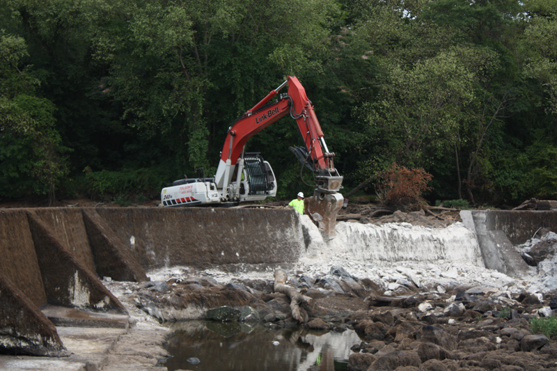 Excavator Removing Dam